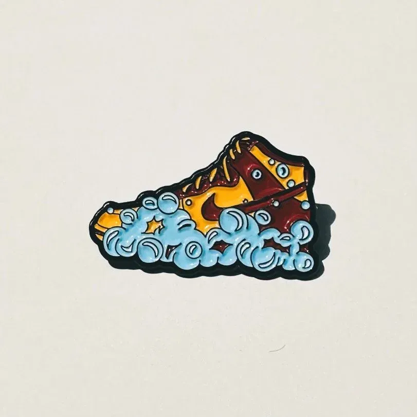Sneaker pin showing a shoe surrounded by cleaning bubbles