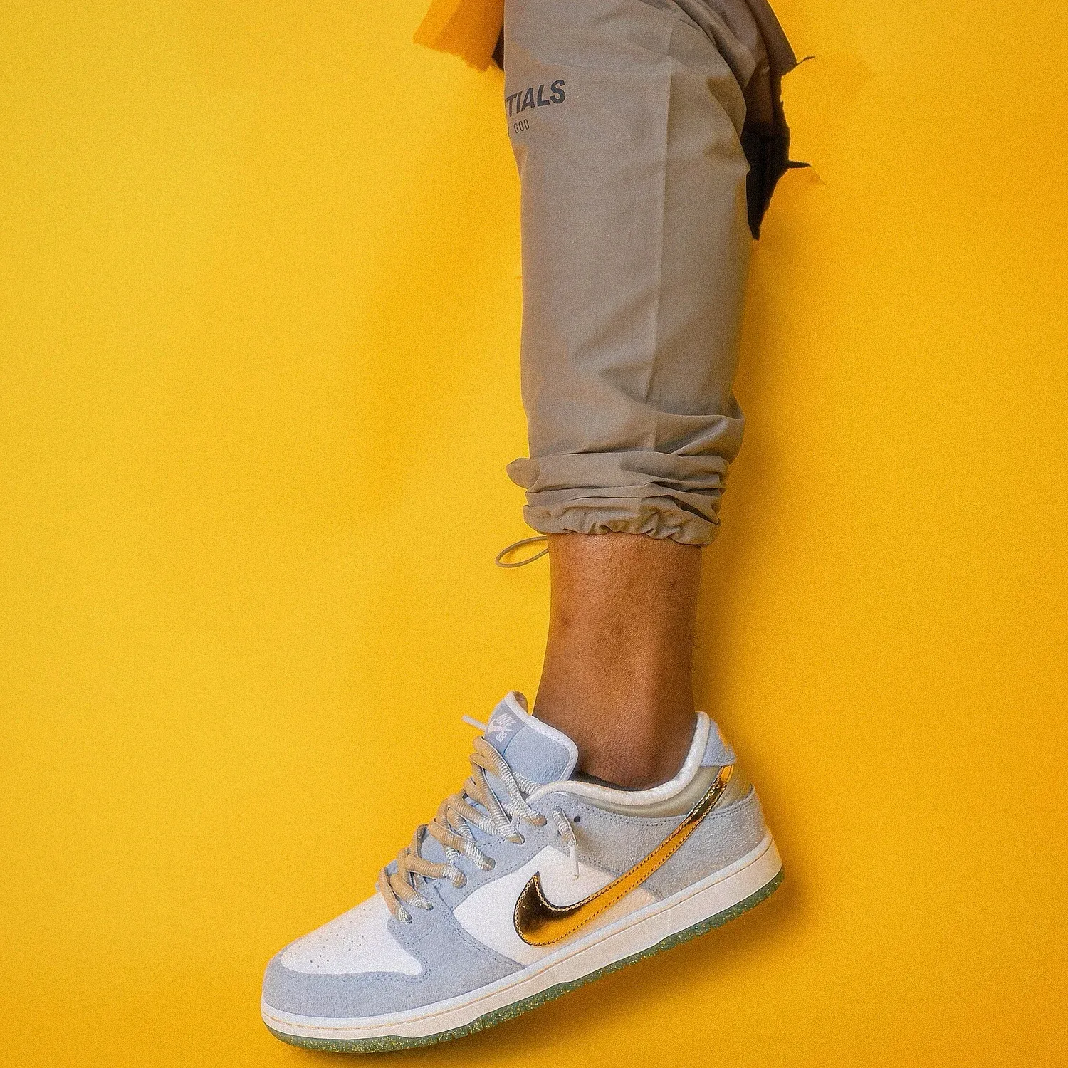 A sneaker mid-step against a yellow backdrop